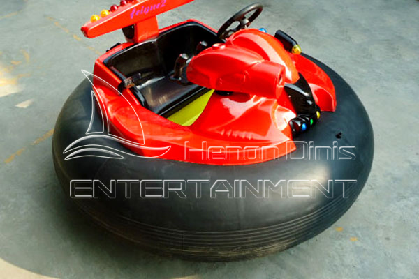 red inflatable bumper car with water gun on water